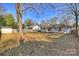 Spacious backyard featuring a shed, mature trees, and a fire pit for outdoor enjoyment at 532 Scaleybark Rd, Charlotte, NC 28209