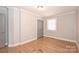 Spacious bedroom with hardwood floors and neutral gray walls at 532 Scaleybark Rd, Charlotte, NC 28209