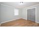 Simple bedroom with hardwood floors, neutral walls, and double doors at 532 Scaleybark Rd, Charlotte, NC 28209