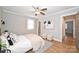 Cozy bedroom featuring a ceiling fan, hardwood floors, and neutral decor at 532 Scaleybark Rd, Charlotte, NC 28209