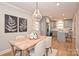 Bright dining area with farmhouse table and gray kitchen visible at 532 Scaleybark Rd, Charlotte, NC 28209