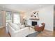 Bright living room featuring a fireplace, hardwood floors, and sliding glass doors to the backyard at 532 Scaleybark Rd, Charlotte, NC 28209