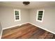 Bright bedroom with hardwood floors and two windows at 700 Oak St, Charlotte, NC 28214