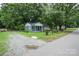 Newly renovated home with gravel driveway and mature trees at 700 Oak St, Charlotte, NC 28214