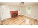 Living room with hardwood floors, brick fireplace, and lots of natural light at 700 Oak St, Charlotte, NC 28214