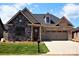 Craftsman style home with stone and brick exterior, two-car garage, and landscaped yard at #77 Silver Trace Ln, Denver, NC 28037