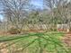 A spacious, grassy backyard is enclosed by a wood fence, offering privacy at 833 Montford Dr, Charlotte, NC 28209