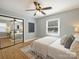 Light-filled bedroom features a ceiling fan, a modern rug and a mirrored closet, offering both style and functionality at 833 Montford Dr, Charlotte, NC 28209