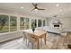 Sunlit dining area with large windows, adjacent to the living room with fireplace at 833 Montford Dr, Charlotte, NC 28209