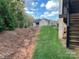 Landscaped backyard with a sloped yard and deck at #89 Silver Trace Ln, Denver, NC 28037