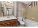 Bathroom with shower/tub combo, wood vanity, and vintage wallpaper at 9153 Spyglass Pl # B, Charlotte, NC 28214