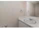 Simple bathroom with a vanity sink, mirror, and neutral colored walls at 9153 Spyglass Pl # B, Charlotte, NC 28214