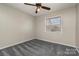 Spacious bedroom with grey carpet and ceiling fan at 9153 Spyglass Pl # B, Charlotte, NC 28214