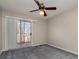 Bedroom with sliding glass door to deck and grey carpet at 9153 Spyglass Pl # B, Charlotte, NC 28214