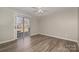 Bedroom with wood-look floors, neutral walls, and sliding glass doors to a patio at 9153 Spyglass Pl # B, Charlotte, NC 28214