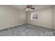 Spacious bedroom with grey carpet and ceiling fan at 9153 Spyglass Pl # B, Charlotte, NC 28214