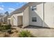 Tan colored townhouse exterior with a covered entryway and small patio area at 9153 Spyglass Pl # B, Charlotte, NC 28214