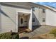 Inviting exterior of a light beige townhouse with a covered entryway and small patio at 9153 Spyglass Pl # B, Charlotte, NC 28214