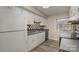 Kitchen with white cabinets, black and white checkered backsplash, and modern appliances at 9153 Spyglass Pl # B, Charlotte, NC 28214