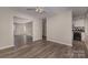 Open living room with a view of the kitchen and wood-look flooring at 9153 Spyglass Pl # B, Charlotte, NC 28214