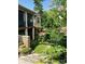 An inviting backyard with tiered landscaping, flowering bushes, and upper level deck at #97 Silver Trace Ln, Denver, NC 28037