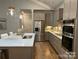Modern kitchen with stainless steel appliances, custom cabinets, and a quartz countertop island at #97 Silver Trace Ln, Denver, NC 28037