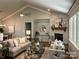 Bright living room featuring a stone fireplace, soaring ceiling, and an open floor plan at #97 Silver Trace Ln, Denver, NC 28037