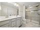 Modern bathroom with double vanity, large shower, and updated fixtures at 9706 Hamel St, Charlotte, NC 28215