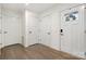 Clean and spacious entryway with hardwood floors and white doors at 9706 Hamel St, Charlotte, NC 28215