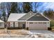 Charming two-story home with two-car garage and snowy front yard at 9706 Hamel St, Charlotte, NC 28215