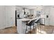 Modern kitchen with white cabinets, island, and stainless steel appliances at 9706 Hamel St, Charlotte, NC 28215