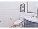 Small bathroom with white shiplap walls and a dark vanity at 9806 Penn Station St, Cornelius, NC 28031