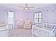 Charming Bedroom features a crib, rocker, and ample natural light at 9806 Penn Station St, Cornelius, NC 28031