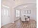 Bright dining room with hardwood floors and a modern table at 9806 Penn Station St, Cornelius, NC 28031