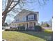 Two-story house with gray and beige siding, front porch, and manicured lawn at 9806 Penn Station St, Cornelius, NC 28031