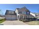 Two-story house with beige siding, two-car garage, and landscaping at 9806 Penn Station St, Cornelius, NC 28031