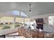 Relaxing sunroom with fireplace, TV, and ample seating at 9806 Penn Station St, Cornelius, NC 28031