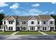 Three-unit townhome building with modern design and landscaping at 10123 Mamillion Dr, Huntersville, NC 28078