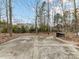 Spacious backyard with a concrete slab, surrounded by trees and foliage at 11107 Balata Ct, Charlotte, NC 28269