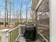 Outdoor deck area with a grill and a view of the surrounding trees at 11107 Balata Ct, Charlotte, NC 28269