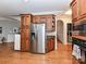 Kitchen with stainless steel refrigerator and wood cabinets. Washer and dryer visible in background at 11107 Balata Ct, Charlotte, NC 28269