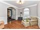 Cozy living room featuring hardwood floors, light gray walls with white trim, arched doorways, and comfortable seating at 11107 Balata Ct, Charlotte, NC 28269