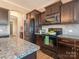 Granite countertop kitchen island with modern gas range and microwave at 112 Meadowcreek Village Dr, Locust, NC 28097