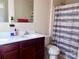Bright bathroom featuring double vanity with white countertop, a large mirror, and a shower with curtain at 1148 Tangle Ridge Se Dr, Concord, NC 28025