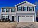 Two-story house with gray siding, black shutters, and a two-car garage at 1148 Tangle Ridge Se Dr, Concord, NC 28025