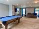 Spacious game room with a pool table, TV, and comfortable seating area at 1148 Tangle Ridge Se Dr, Concord, NC 28025