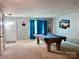 This game room is perfect for entertaining with a pool table and comfortable seating at 1148 Tangle Ridge Se Dr, Concord, NC 28025