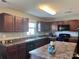 Well-equipped kitchen with dark wood cabinets and a large center island at 1148 Tangle Ridge Se Dr, Concord, NC 28025