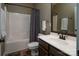 Well-lit bathroom showcases a shower-tub combo, modern vanity, and fresh white towels at 13228 Kennerly Dr, Huntersville, NC 28078