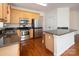 Modern kitchen featuring stainless steel appliances, a granite countertop, and wooden cabinets at 13228 Kennerly Dr, Huntersville, NC 28078